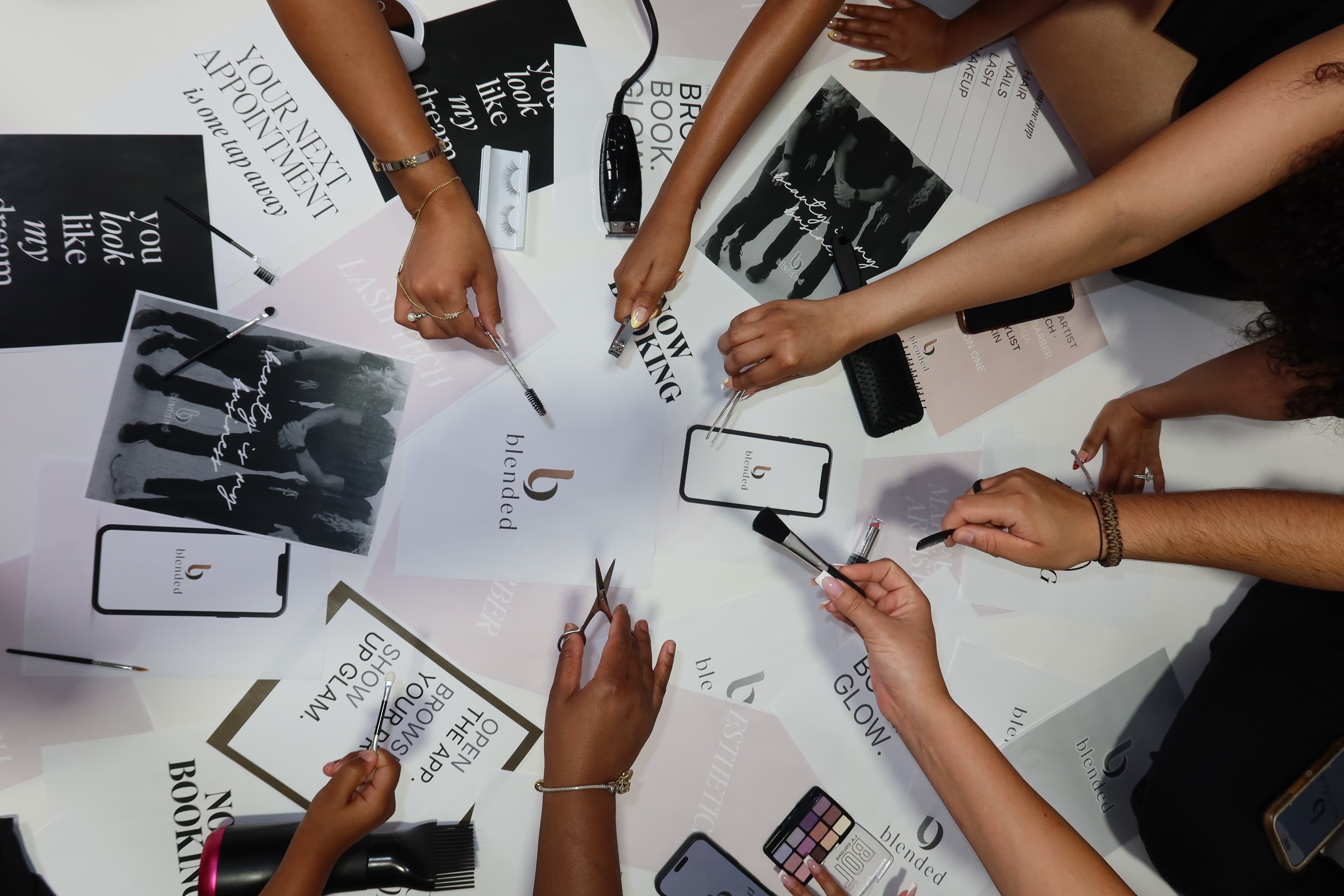 Beauty tools and hands arranged across a Blended editorial mood board